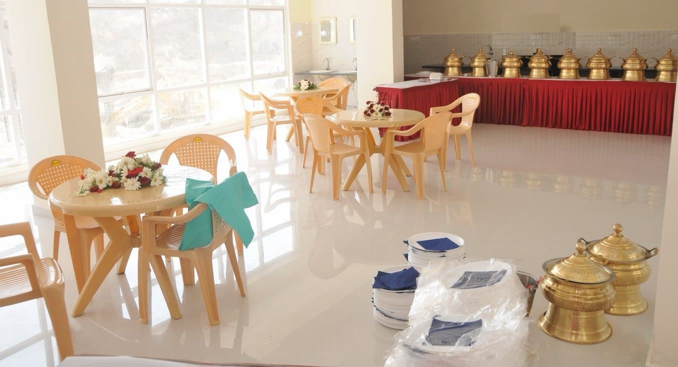 The cafeteria and multi-purpose hall laid out for an event, with tables by the windows