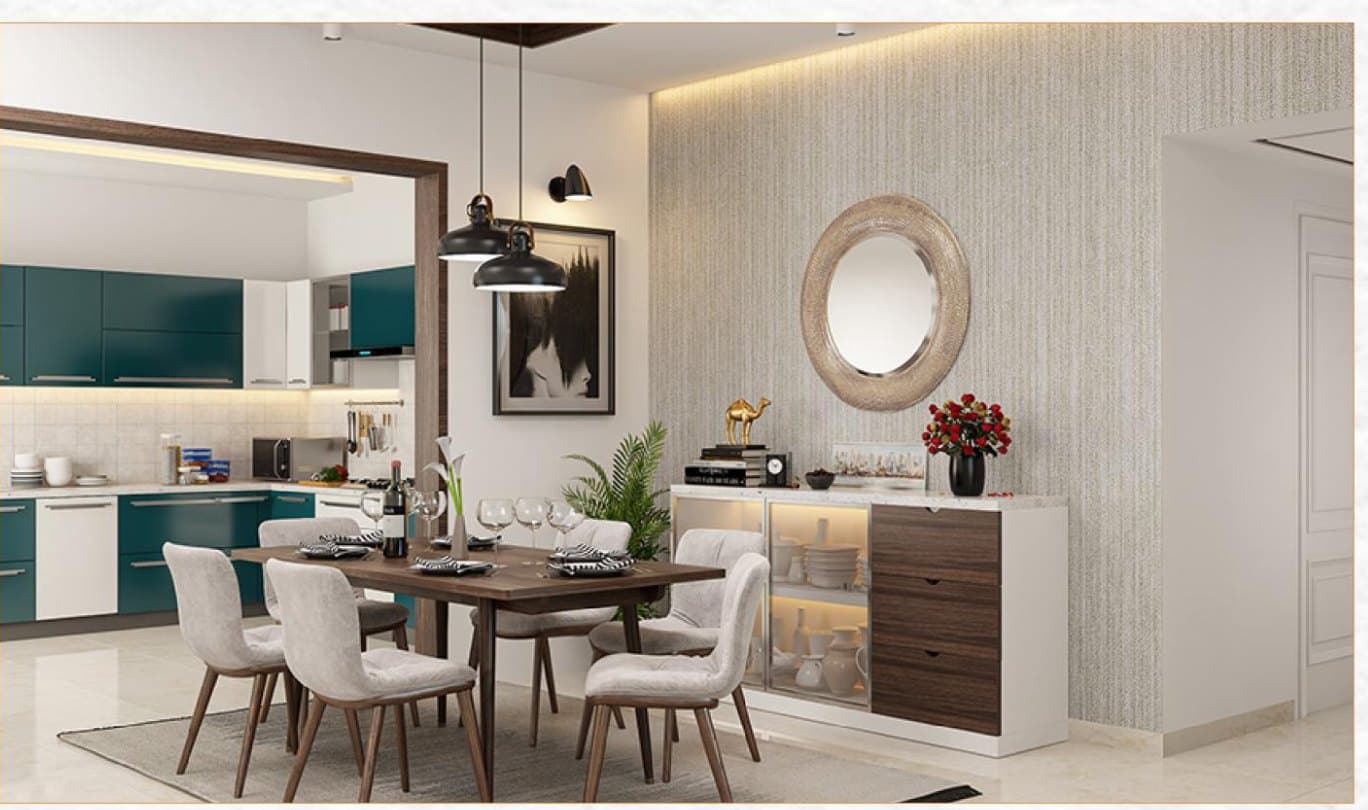 A dining room with a round mirror over the sideboard and the teal kitchen beyond