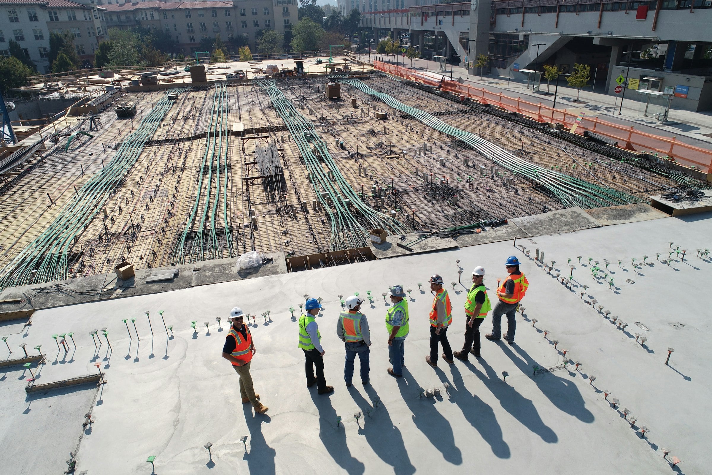 Site engineers and workers walking a large concrete deck
